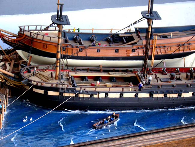 A fabulous and highly detailed scale model diorama circa 1920 of a New England Ship yard circa 1800-1812 making repairs on a 38 Gun American Frigate and a 10 Gun Privateer built circa 1785. — image 3